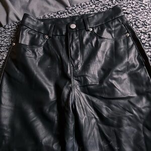 Black leather straight leg pants with zipper fly and button closure #leatherpant